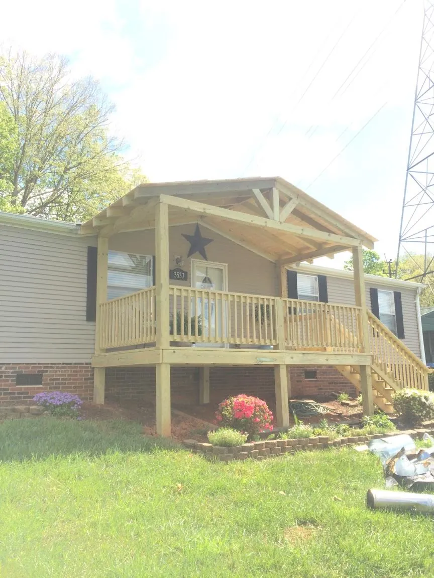 New gabled porch roof and deck railing added to a ranch home in New Caney
